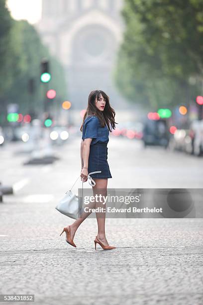 Sarah Benziane , is wearing a Zara blue shirt, a New Look blue skirt, Texto nude shoes, a Lancaster white bag, and a Michael Kors pompom, during a...