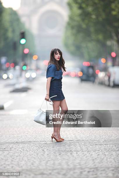 Sarah Benziane , is wearing a Zara blue shirt, a New Look blue skirt, Texto nude shoes, a Lancaster white bag, and a Michael Kors pompom, during a...