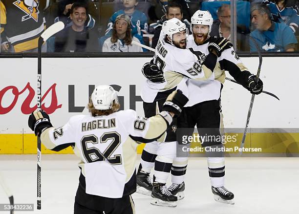 Ian Cole of the Pittsburgh Penguins celebrates with Kris Letang and Carl Hagelin after scoring against the San Jose Sharks in the first period of...