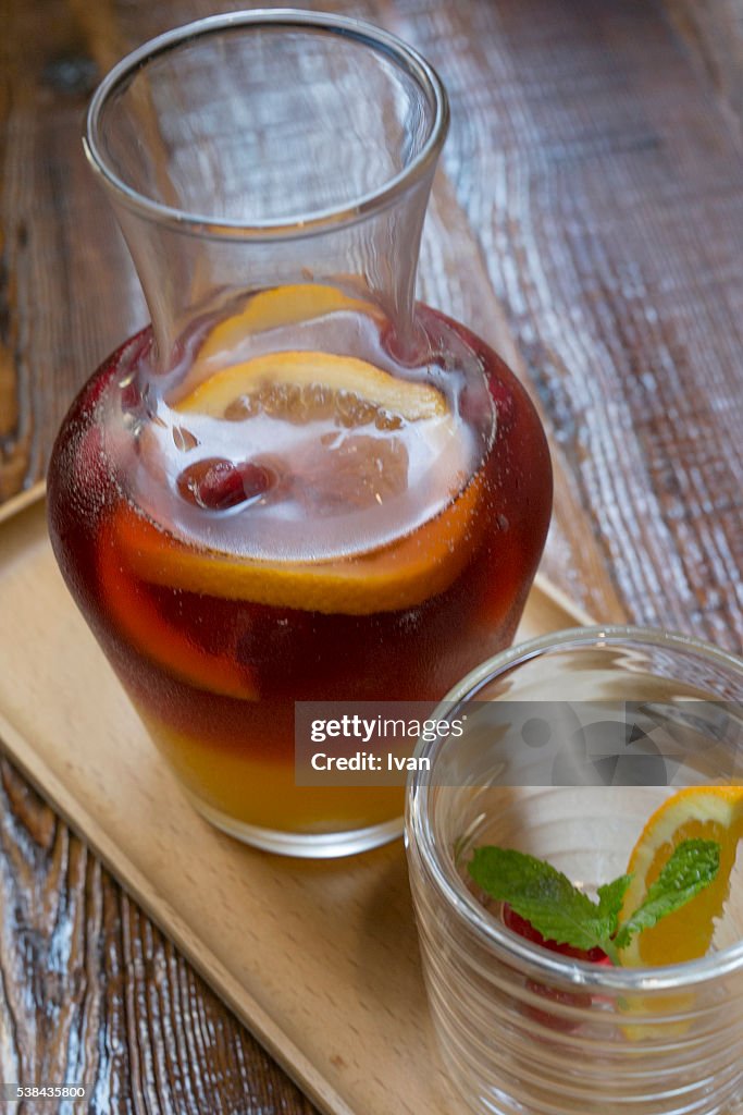 Ice Cold Glass of Raspberry Iced Tea Over Ice Cubes