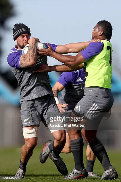 Elliot Dixon of the All Blacks is tackled by Waisake Naholo during a New Zealand All Blacks training session at Trusts Stadium on June 7, 2016 in...