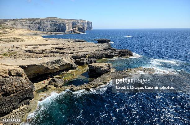 rocky shore and cliffs near the azure window, gozo island, malta - azure window malta stock pictures, royalty-free photos & images