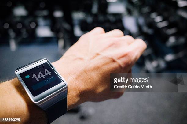 smartwatch showing pulse. - sporting term stock pictures, royalty-free photos & images