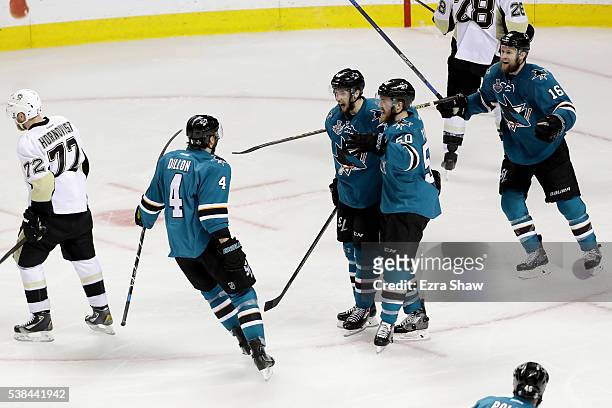Melker Karlsson of the San Jose Sharks celebrates with Brenden Dillon and Chris Tierney after scoring against the Pittsburgh Penguins in the third...