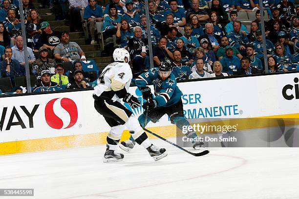 Nick Spaling of the San Jose Sharks dumps the puck past Justin Schultz of the Pittsburgh Penguins in Game Four of the 2016 NHL Stanley Cup Final at...