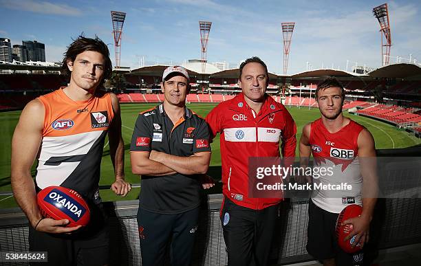 Giants coach Leon Cameron, Phil Davis of the Giants, Swans coach John Longmire and Kieren Jack of the Swans pose during an AFL press conference at...