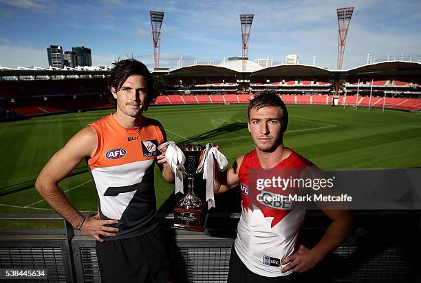 Phil Davis of the Giants and Kieren Jack of the Swans hold the White Ribbon Trophy during an AFL press conference at Spotless Stadium on June 7, 2016...