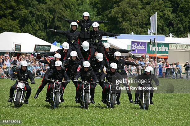 motor cycle display team, perform a tricky pyramid move - human pyramid stock pictures, royalty-free photos & images