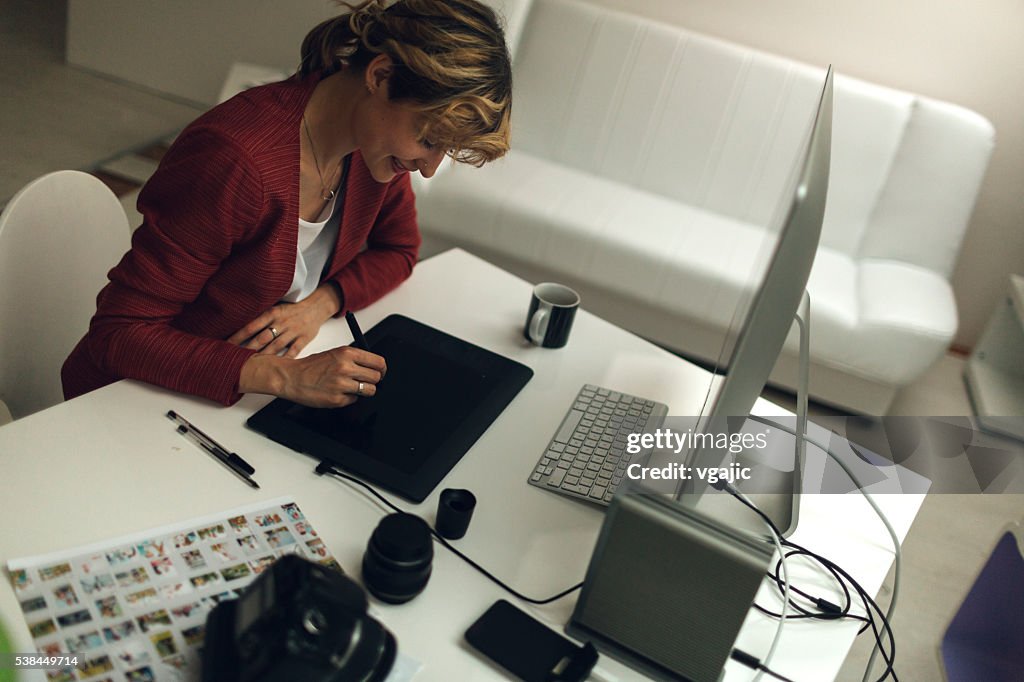 Photographer Working In Her Office