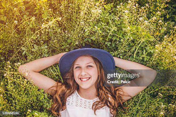 teenage girl daydreaming in the grass - shepherds purse stock pictures, royalty-free photos & images