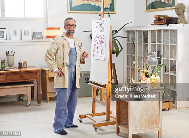portrait of senior man at his home art studio - gray jumpsuit stock pictures, royalty-free photos & images