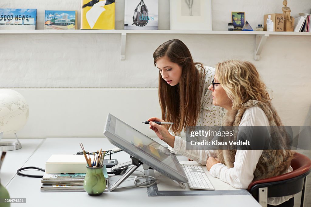 Mature woman showing intern graphics on screen