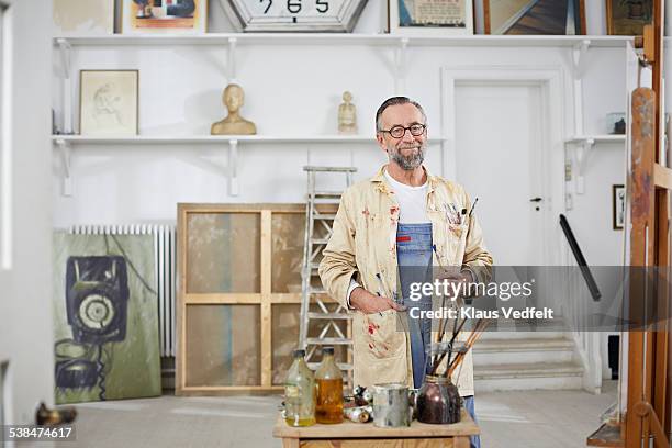 portrait of mature man in his home art studio - artist portrait stock pictures, royalty-free photos & images