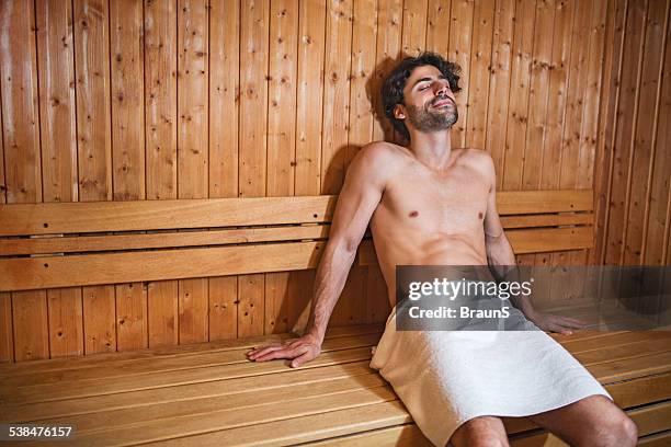 young man in sauna. - sauna stockfoto's en -beelden