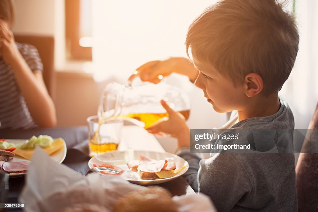 Kids eating breakfast on sunny morning