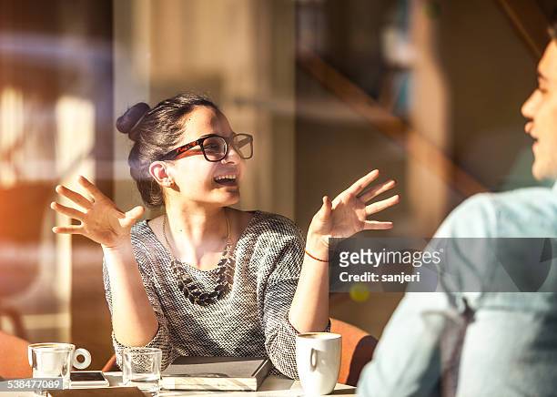 young couple having fun at the coffee shop - cool attitude stockfoto's en -beelden