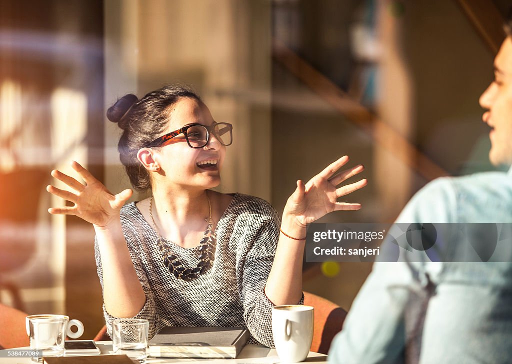 Young couple having fun at the coffee shop