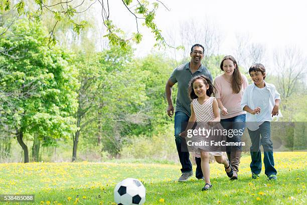 playing soccer at the park - indian football stock pictures, royalty-free photos & images