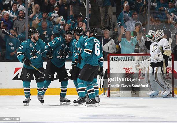 Chris Tierney, Nick Spaling, Brenden Dillon and Melker Karlsson of the San Jose Sharks celebrate Karlsson's goal as goaltender Matt Murray of the...