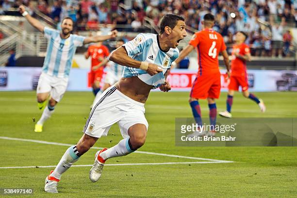 Angel Di Maria of Argentina celebrates after scoring the first goal against Chile in the second half during a group D match between Argentina and...