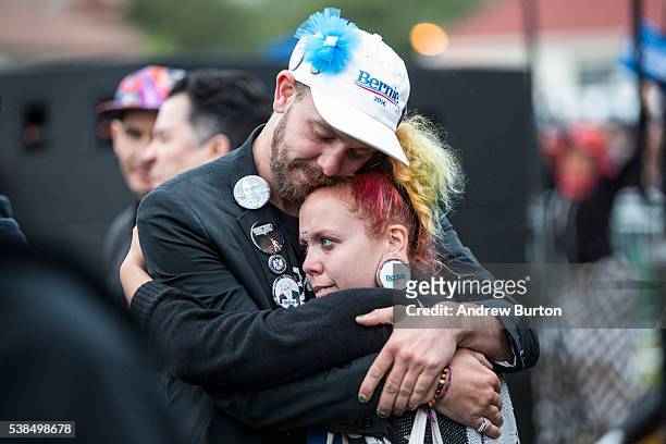 Fans of Democratic presidential candidate Senator Bernie Sanders embrace during a rally at the Presidio on June 6, 2016 in San Francisco, California....