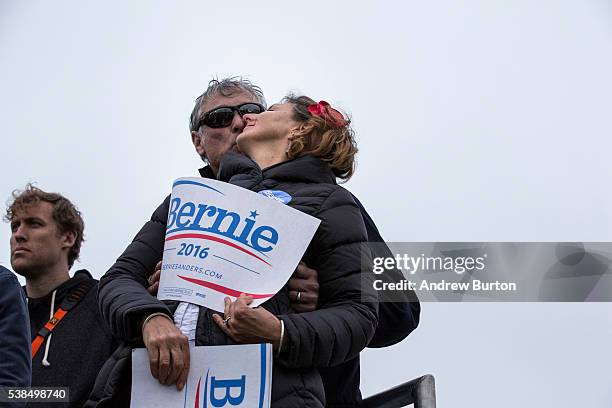 Fans of Democratic presidential candidate Senator Bernie Sanders embrace during a rally at the Presidio on June 6, 2016 in San Francisco, California....