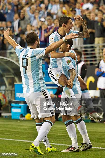 Angel Di Maria of Argentina celebrates with Ever Banega and Gonzalo Higuain after scoring the first goal against Chile in the second half during a...