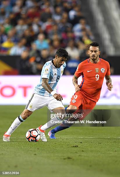 Augusto Fernandez of Argentina dribbles the ball away from Mauricio Pinilla of Chile during the 2016 Copa America Centenario Group match play between...