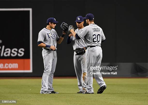 Steven Souza Jr, Mikie Mahtook and Desmond Jennings of the Tampa Bay Rays celebrate a 6-4 win against the Arizona Diamondbacks at Chase Field on June...