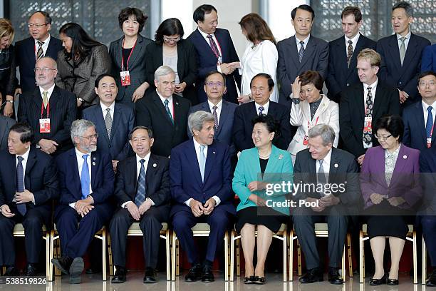 Secretary of State John Kerry chats with Chinese Vice Premier Liu Yandong (front row, during a group photo session with delegations for the Plenary...