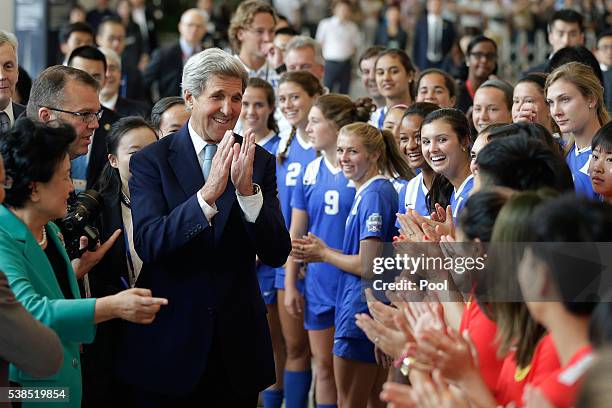 Secretary of State John Kerry gestures as he and Chinese Vice Premier Liu Yandong meet female soccer players from U.S. And China during the Plenary...