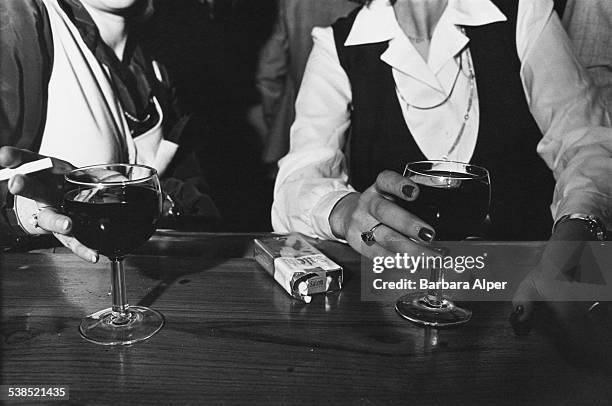 Two women drinking and smoking in a bar in Boston, Massachusetts, 1st March 1979.