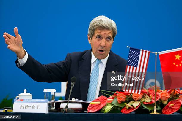 Secretary of State John Kerry gestures as he speaks during the plenary session of the 7th annual U.S.-China High-Level Consultation on...