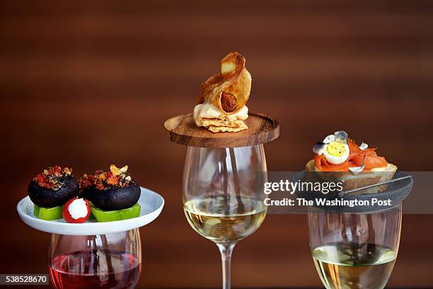 Left to right: Stuffed Cremini Mushrooms, Potato-Wrapped Chorizo Wrapped With Membrillo Aioli and Smoked Salmon With Quail Eggs photographed in...