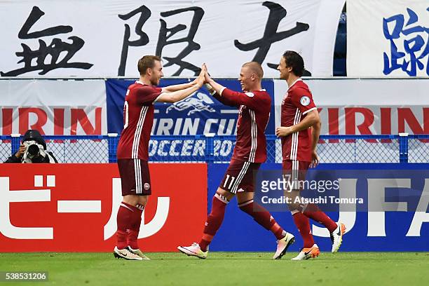Christian Eriksen of Denmark celebrates scoring his team's second goal with his team mates Viktor Fischer and Thomas Delaney during the international...