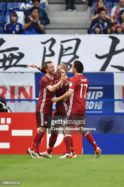 Christian Eriksen of Denmark celebrates scoring his team's second goal with his team mates Viktor Fischer and Thomas Delaney during the international...