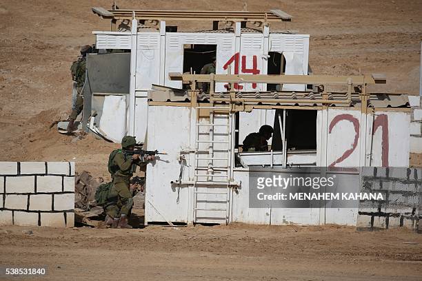 Israeli soldiers take positon during a joint army drill which includes infantry, aviation, tanks and artillery units in the army training base of...