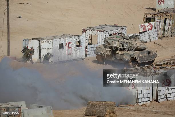Israeli soldiers take positon during a joint army drill which includes infantry, aviation, tanks and artillery units in the army training base of...