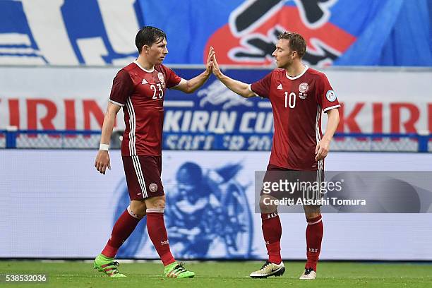 Christian Eriksen of Denmark celebrates scoring his team's third goal with his team mate Pierre-Emile Hojbjerg during the international friendly...