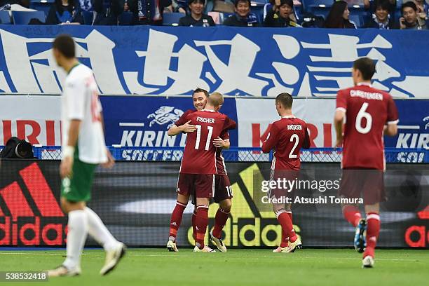 Christian Eriksen of Denmark celebrates his team's fourth and hat trick goal with his team mates during the international friendly match between...