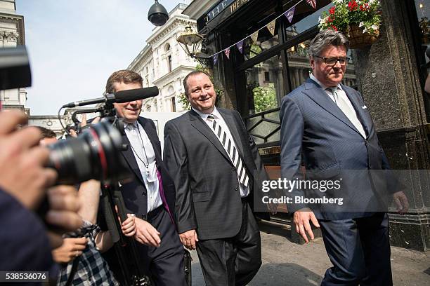 Mike Ashley, billionaire founder of Sports Direct International Plc, second right, arrives to give evidence at a Business, Innovation and Skills...