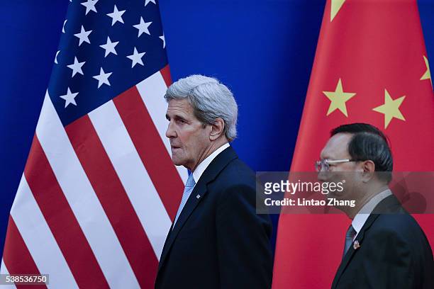 United States Secretary of State John Kerry with Chinese State Councilor Yang Jiechi arrive to the closing ceremony of the eighth round of US-China...