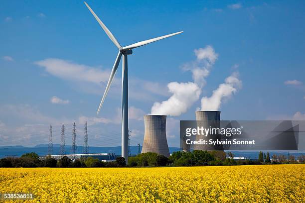 nuclear station and wind turbine - nuclear power station stock pictures, royalty-free photos & images