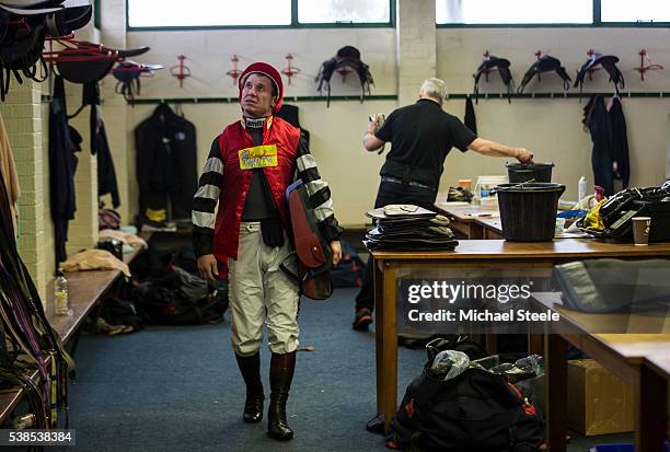 Richard Johnson looks up at the eevision screen as he leaves the jockeys changing room to weigh in at Exeter Racecourse ahead of his only race of the...