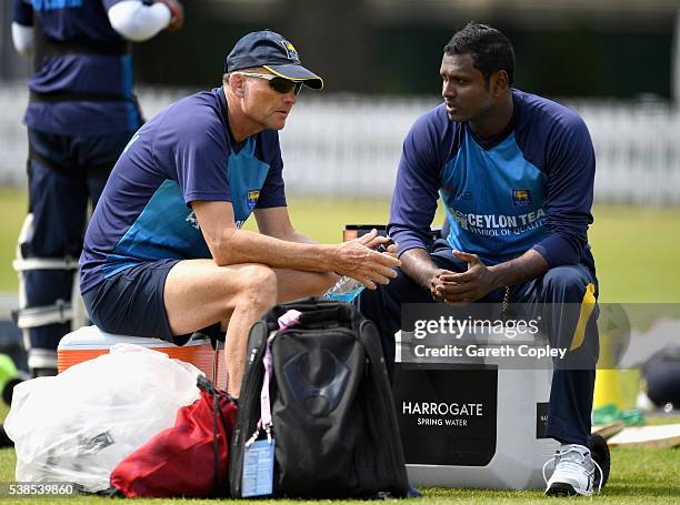 Angelo Mathews of Sri Lanka speaks with coach Graham Ford during a nets session ahead of the 1st Investec Test match between England and Sri Lanka at...