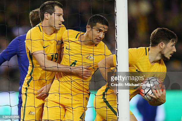 Trent Sainsbury of the Socceroos celebrates a goal with Ryan McGowan and Tim Cahill during the International Friendly match between the Australian...