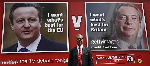 Leader Nigel Farage poses for photographers as he unveils a new campaign poster Ahead Of a televised debate with the Prime Minister later today on...
