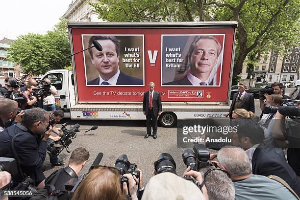 Party leader Nigel Farage stands in front of a new EU Referendum campaign poster ahead of his debate with the British Prime Minister David Cameron in...