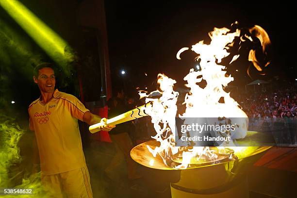 Juiz de Fora, BRAZIL Andre Nascimento lights the pyre in Juiz de Fora during day 7 of the Olympic Flame torch relay on May 7 , 2016 in Brasilia,...