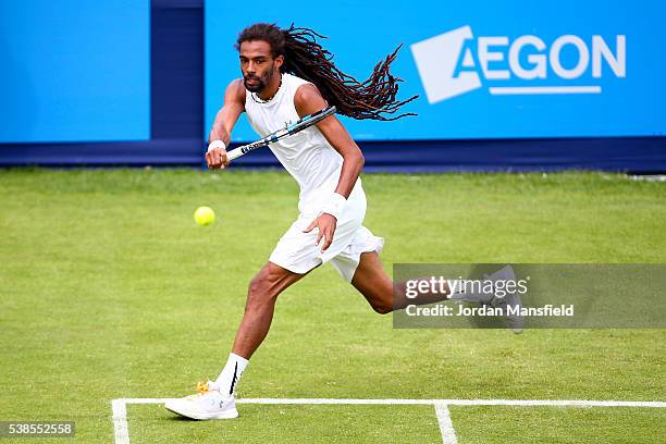 Dustin Brown of Germany reaches for a forehand during his first round match against Eduardo Struvay of Colombia during day four of the Aegon Surbiton...